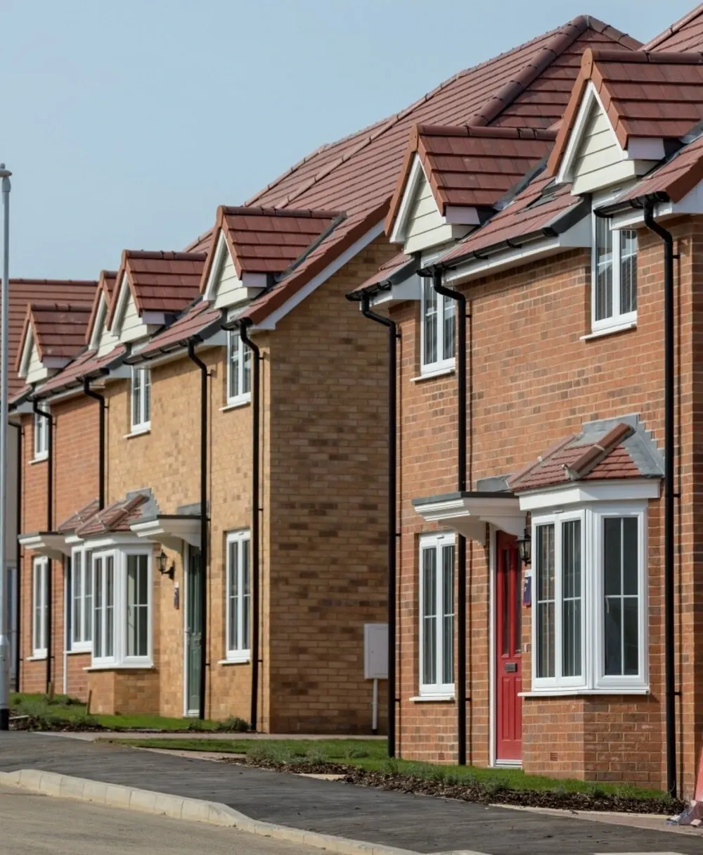 A terrace of newly built brick houses on a residential street